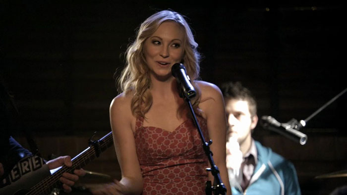 Caroline singing in the pink dress 