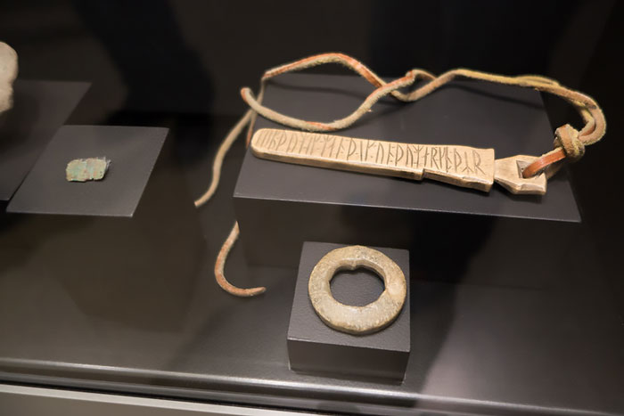 Ancient Viking artifact with runic inscriptions displayed in a museum showcasing interesting Viking facts.