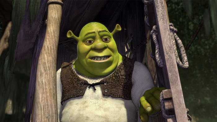 Shrek character smiling in a forest setting, featured in one of the best wedding movies for celebrating love.