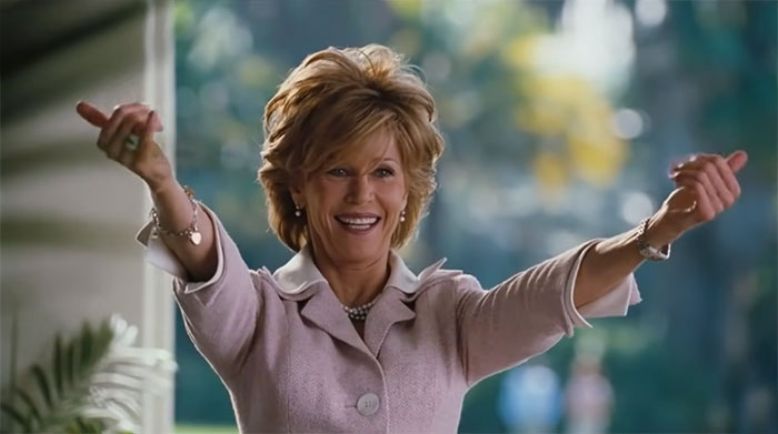 Scene from Monster-In-Law movie featuring a joyful woman celebrating love in one of the best wedding movies ever made.