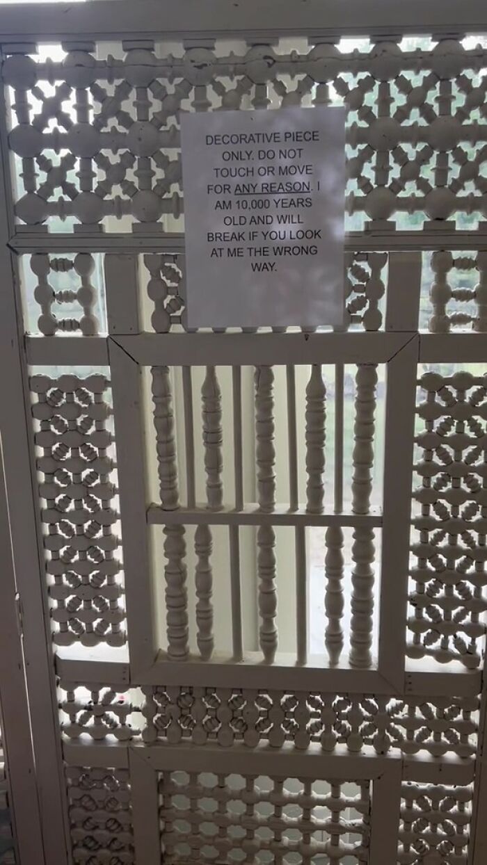 Note with rules posted on decorative piece in an Airbnb, warning guests not to touch or move it for any reason.