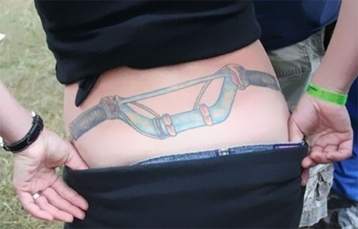 Tattoo on lower back resembling handlebars; a tattoo that made someone walk away from a person.
