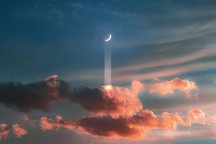 Crescent moon shining bright beams through colorful clouds at sunset, illustrating the limitless sky and human curiosity.