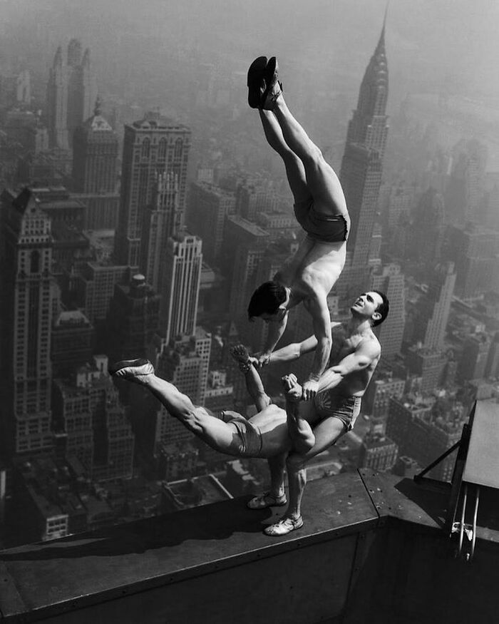 1934. Acrobats Perform A Balancing Act On A Ledge Of The Empire State Building