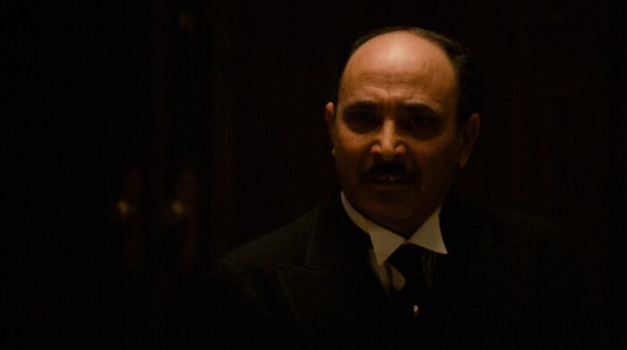 Amerigo Bonasera looking at Don Vito Corleone