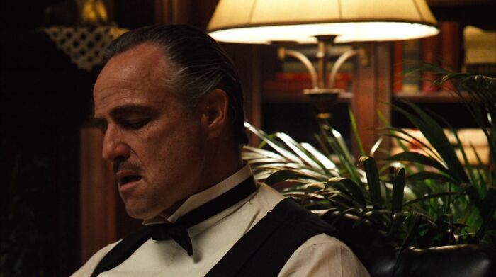 Don Vito Corleone sitting