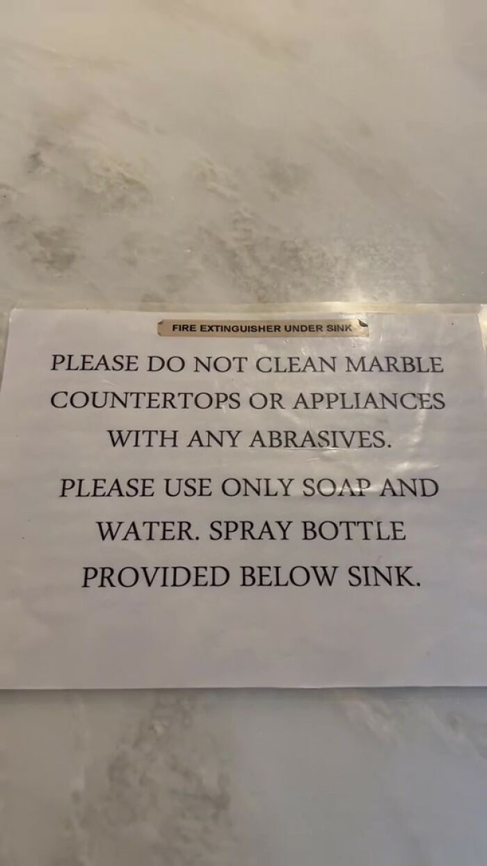 Airbnb rules sign instructing not to clean marble countertops with abrasives and to use soap and water only.