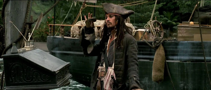Jack Sparrow on a pirate ship making a confused gesture, illustrating human stupidity has no limits humor.