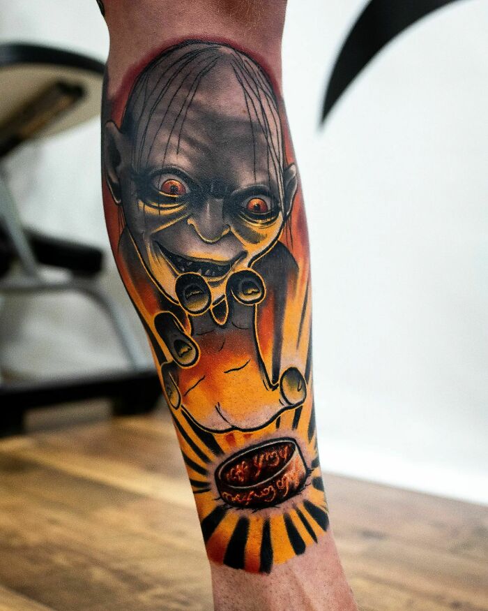 Lord of the Rings tattoo featuring Gollum and the One Ring on a leg.