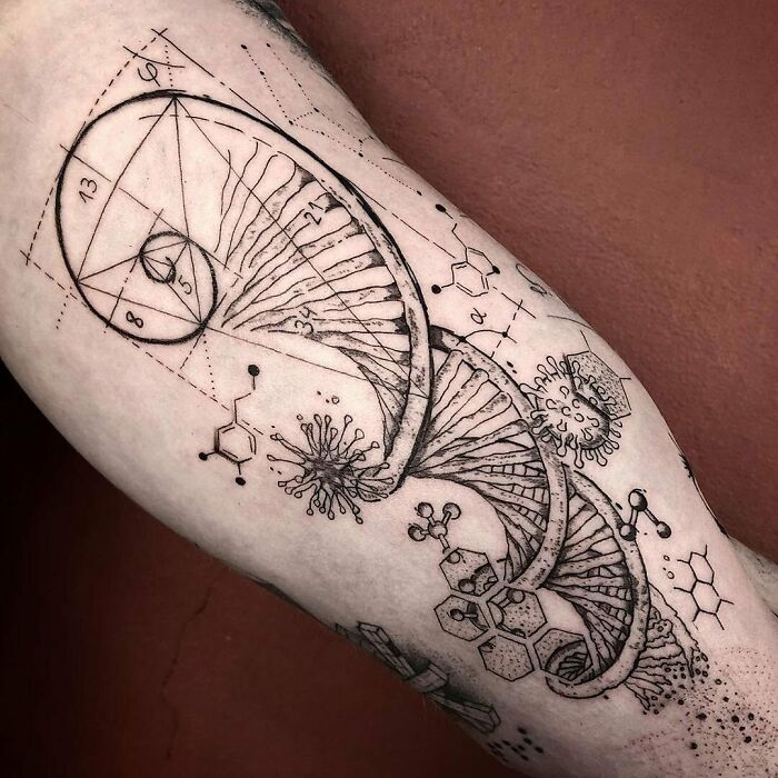 Science tattoo with DNA helix, geometric shapes, and molecular diagrams on arm.
