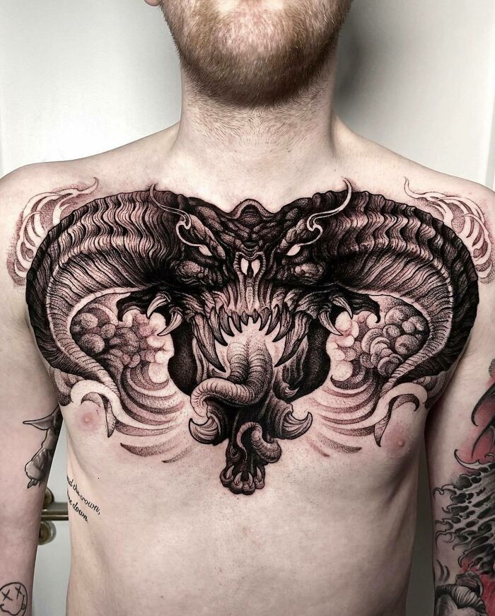 Intricate Lord of the Rings dragon tattoo design on a person's chest.