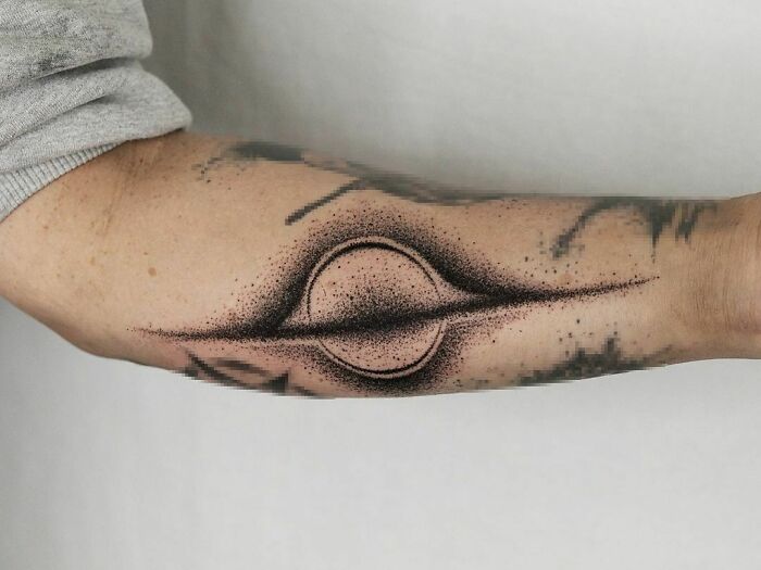 Science tattoo featuring a stylized cosmic design on a person's forearm.