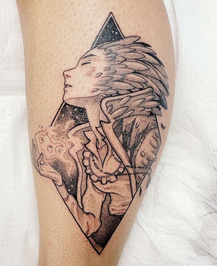 Anime tattoo featuring a character with detailed feathers and a geometric background.