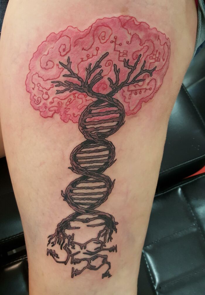 Tree tattoo featuring DNA helix design with roots and branches on a person's skin, celebrating the wonders of nature.