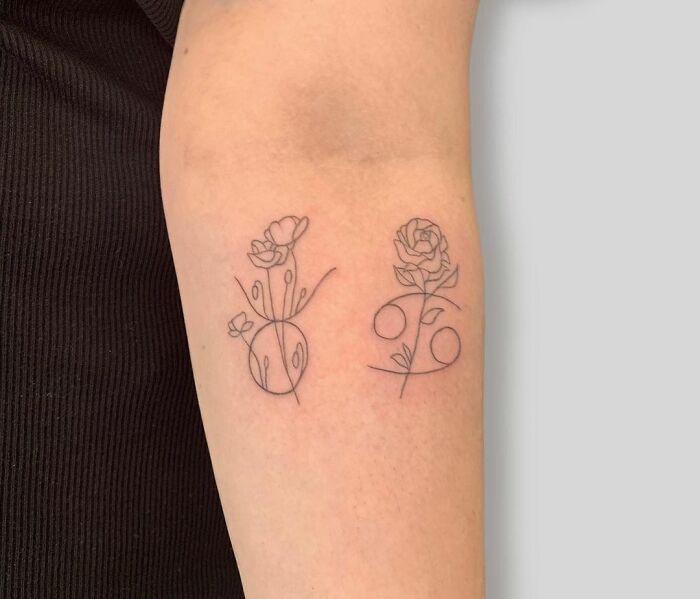 Minimalist zodiac tattoos with floral designs on an arm.