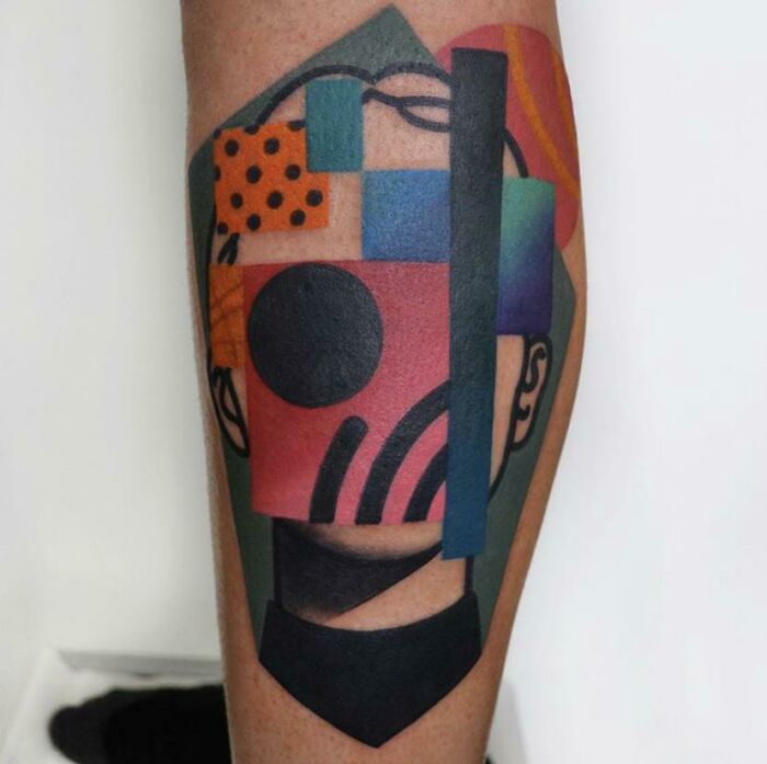 Colorful abstract tattoo design featuring geometric shapes and bold patterns on skin, showcasing artistry and self-expression.
