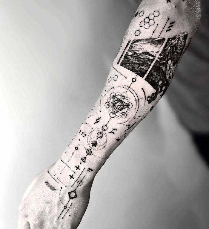 Tattoo featuring scientific symbols and geometric patterns on an arm, representing science themes.