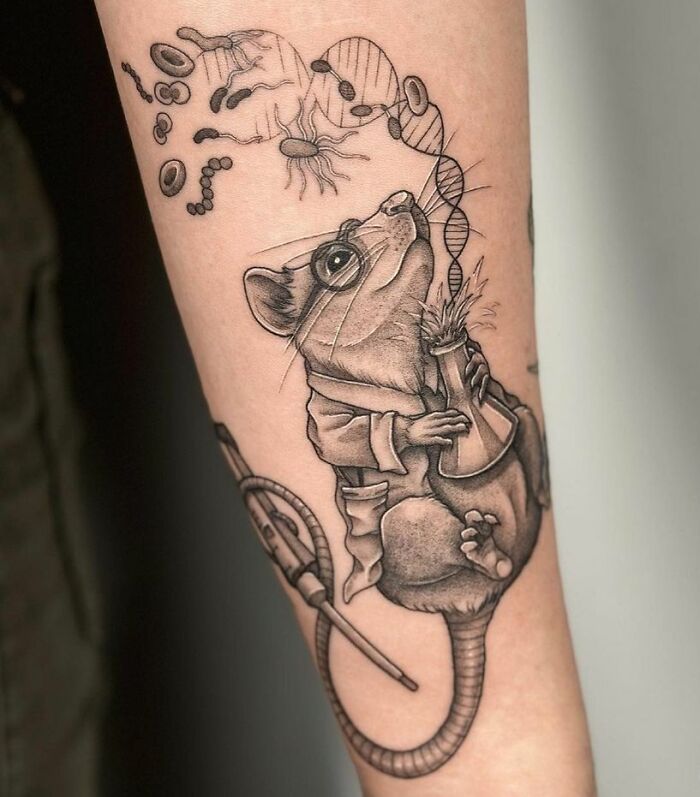 Science tattoo featuring a mouse in a lab coat holding a beaker, with DNA and microbes.