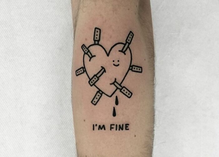 Heart tattoo with bandages and the words "I'm fine," symbolizing mental health healing.