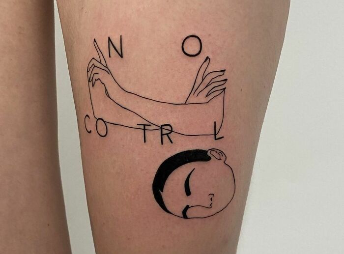 Tattoo of the words "NO CONTROL" with abstract arms and a serene face, symbolizing mental health and healing.