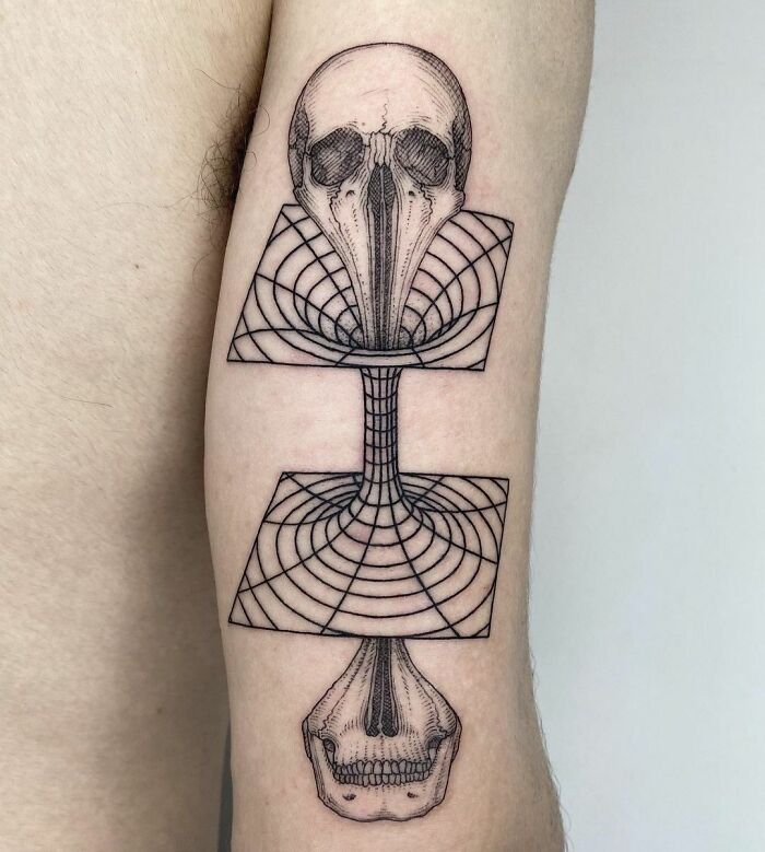 Science tattoo featuring geometric patterns and skulls on an arm, exemplifying scientific artistry.
