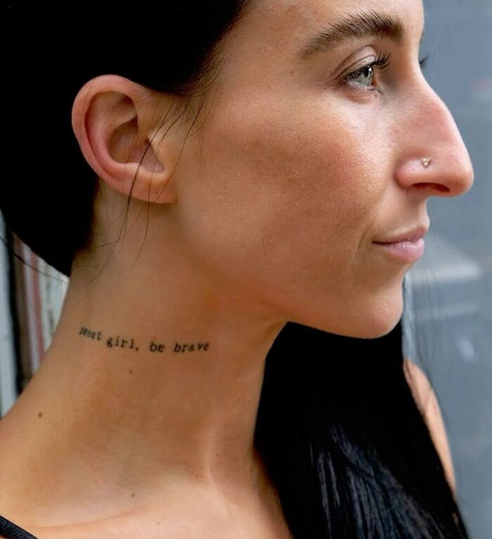 Woman with a mental health tattoo on neck reading "sweet girl, be brave," symbolizing empowerment and bravery.