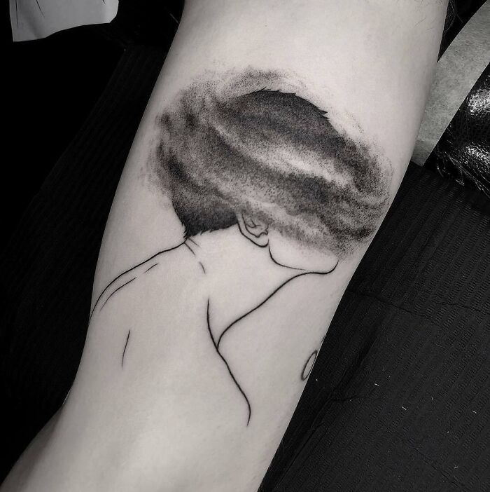 Minimalistic tattoo of a person with a cloud head, representing mental health and healing.