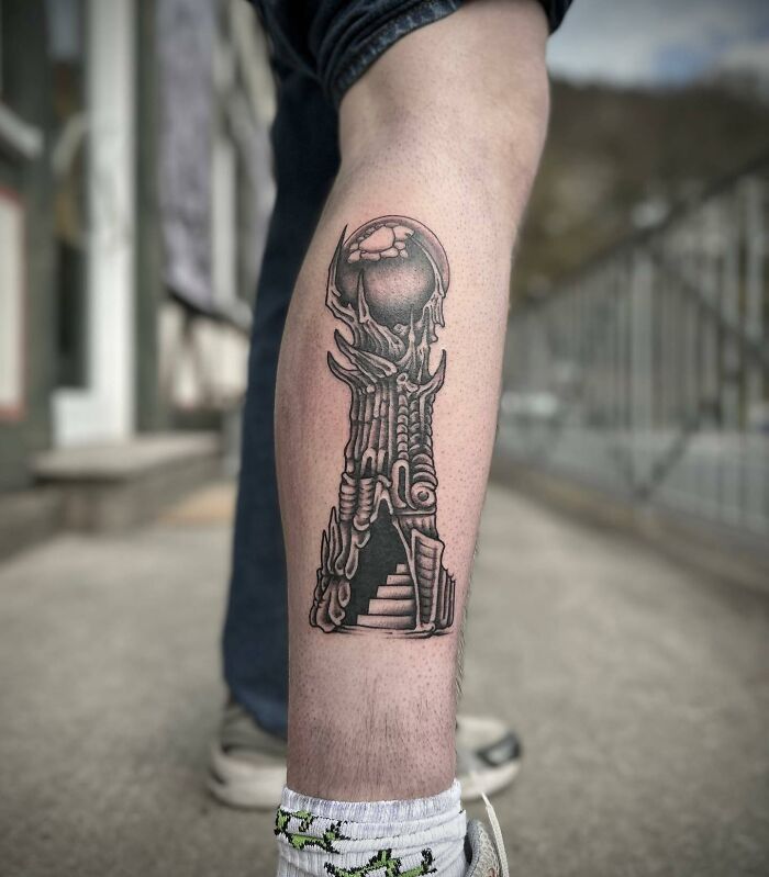 Lord of the Rings tattoo design on a person's leg showcasing intricate tower details.