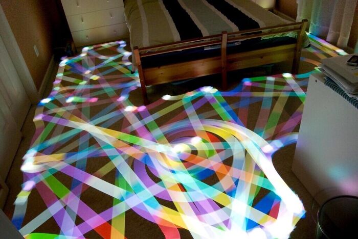 Long Exposure Of A Roomba Vacuum With A Color Changing Light On Top