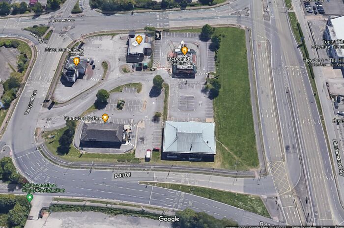 (UK) An Island Of Fast Food Restaurants Surrounded By A Sea Of Lanes