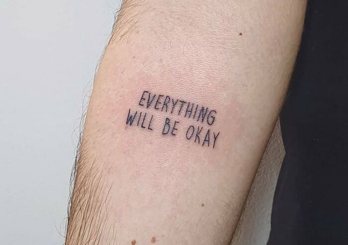 Tattoo on an arm with the phrase "Everything Will Be Okay," symbolizing healing and mental health support.