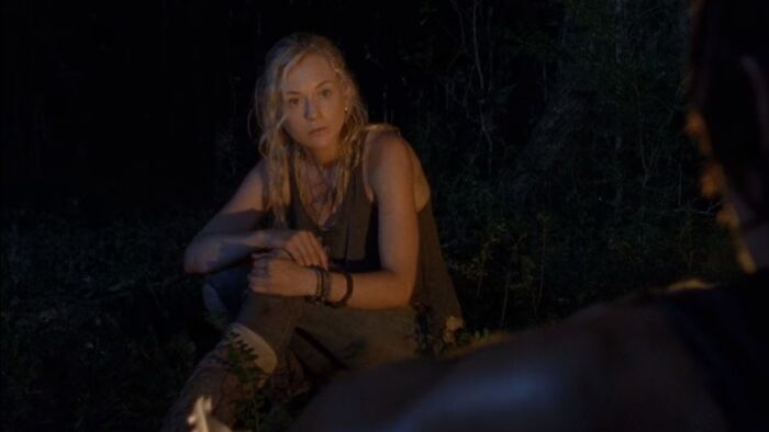 Beth Greene sitting near the fire 