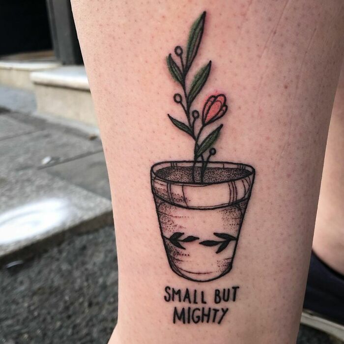 Tattoo of a potted plant with the words "Small but Mighty," symbolizing mental health strength and healing.