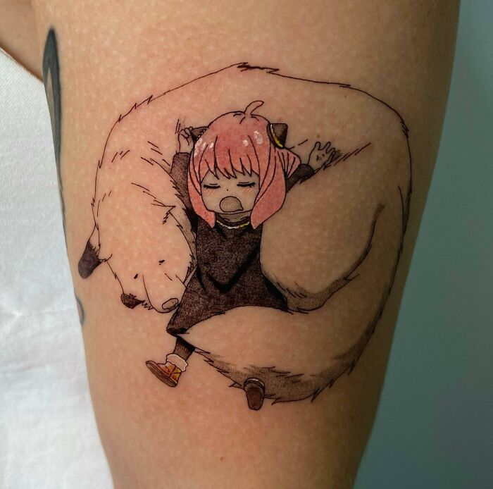 Anime tattoo of a pink-haired character cuddling with a bear, showcasing unique design and vibrant colors.