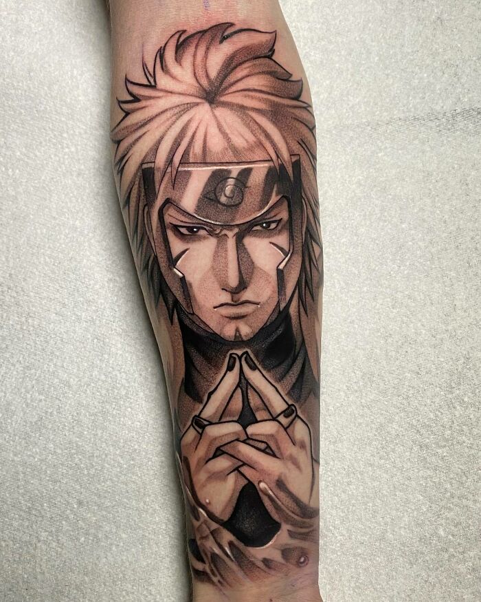 Anime tattoo of a character with spiky hair, wearing a ninja headband, performing a hand sign on a forearm.