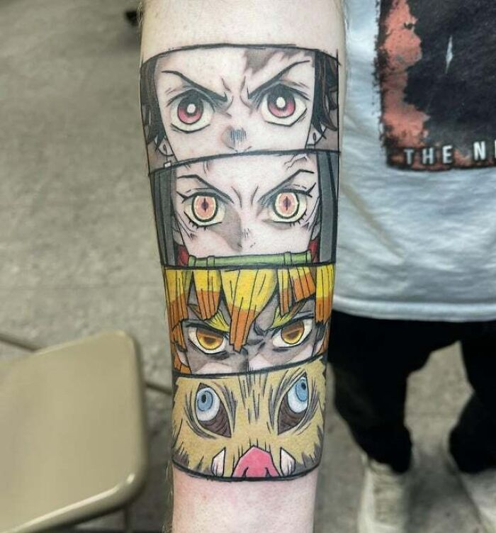Anime tattoos featuring intense character eyes on a forearm, showcasing bold graphic design and vibrant colors.