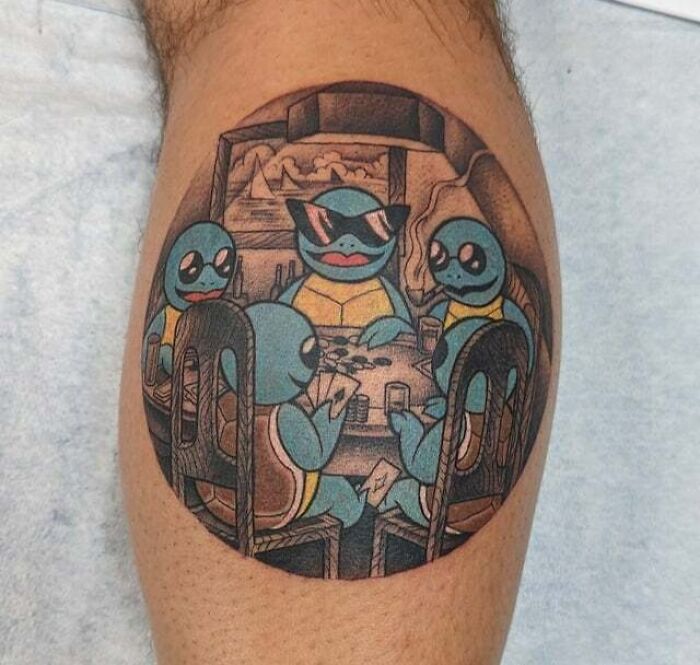 Anime tattoo of turtle-like characters playing poker, stylized on an arm.