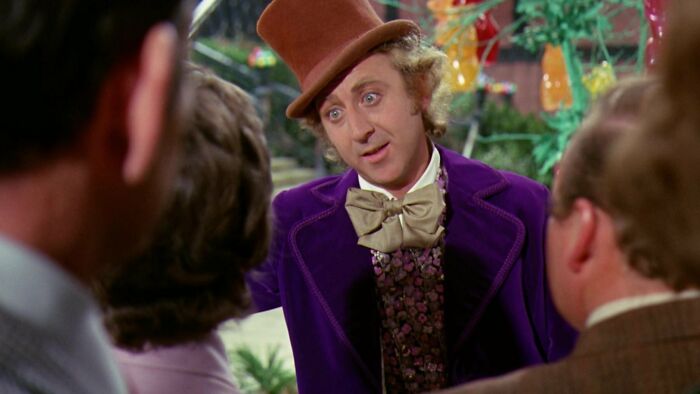 W***y Wonka telling something to his guests 