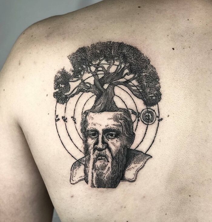 Science tattoo featuring a tree growing from a historical figure's head, emphasizing knowledge and nature.