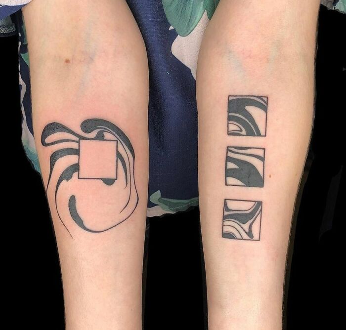 Abstract tattoo designs with wavy and square patterns on forearms.