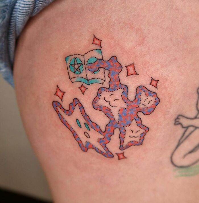 Abstract tattoo with colorful shapes and faces, symbolizing self-expression and artistry.