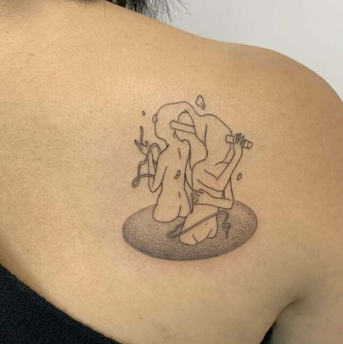 Abstract tattoo on shoulder, featuring two intertwined figures with minimalist line art design.