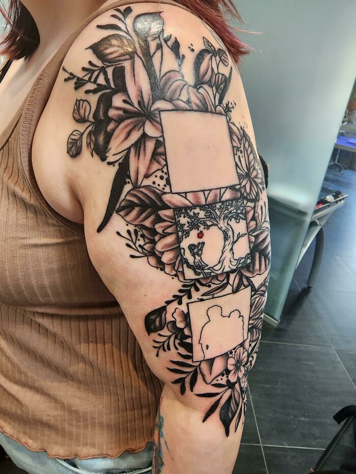 Floral memorial tattoo on upper arm with framed family designs.
