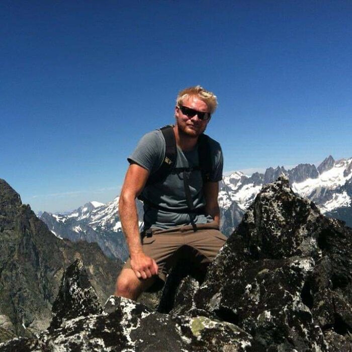 This Picture If A Friend Hiking Makes Him Look Like A Giant Sitting Amongst Mountains