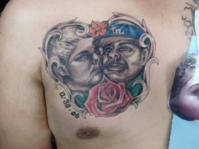 Tattoo of two faces with a rose and date on a chest, depicting common permanent ink mistakes.