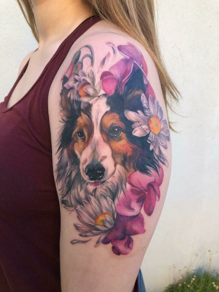 Dog and floral memorial tattoo on woman's arm honoring family.