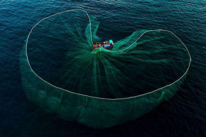 A Fishing Net Spread Across The Waters