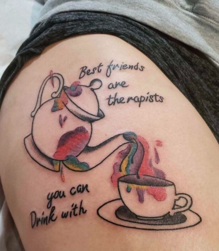 Tattoo of a colorful teapot pouring into a cup with text about friends, illustrating a common inked mistake.