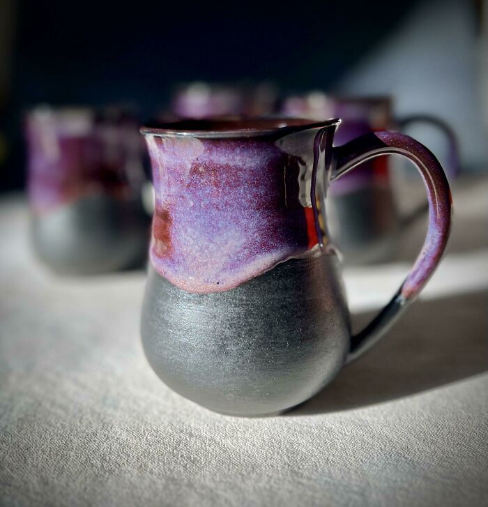 Handcrafted mug with purple and black glaze, showcasing unique design and functionality beyond a typical mug life.