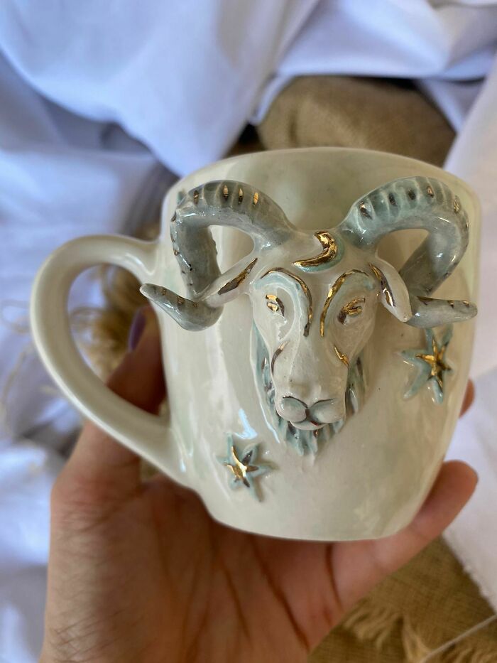 Ceramic mug with a detailed ram head and star decorations, showcasing unique design in awesome mugs for mug life.